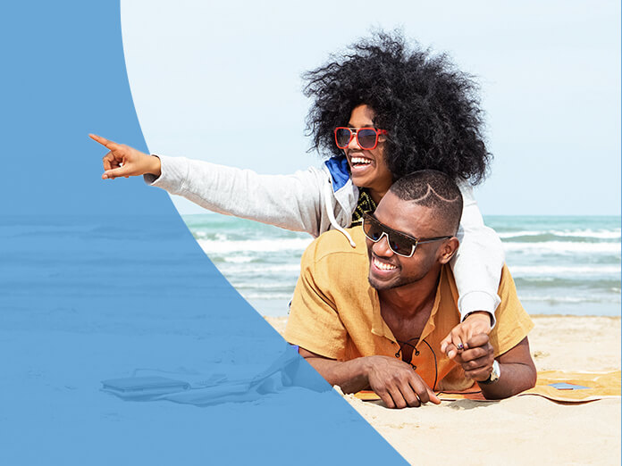 A smiling couple relaxing together on the beach